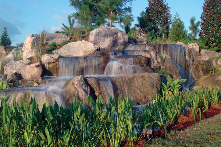 This waterfall sits within a few feet of the main entrance road of a retirement community and provides generous amounts of medium and high-pitch sounds that one would hear in a heavy rainstorm.