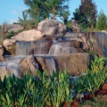 This waterfall sits within a few feet of the main entrance road of a retirement community and provides generous amounts of medium and high-pitch sounds that one would hear in a heavy rainstorm.