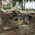 This piece of driftwood adds a nice touch to a pondless waterfall.