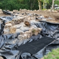 Putting the finishing touches on a black-colored concrete liner. A pondfree stream and falls over 30-mil LLPDE.