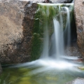 “Glacial Erratic” granite rocks make up this two-stone waterfall. Years of moving ice give these rocks a naturally weathered appearance. This was supposed to be a retaining wall for an upper and lower patio.