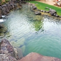 A pondlike NSP (above) in Utah with decorative stone boulders and naturalistic water features (Photo courtesy of Utah Waters Edge).