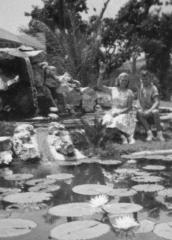 This waterfall was built for the series of five ponds that would flow to the bottom pond, where one of the first Slocum bucket filters was developed.  Mr. Slocum would often recruit local friends and their children (right) to pose on the wondrous Victorias that were grown at the gardens.