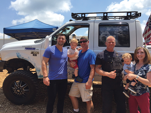 Tim Tebow and Mike Holmes with Tommy Hill, "The Pond Guy of the South" and his family