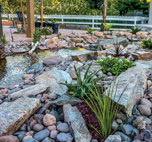Accent stones and desert plants in pondless waterfall