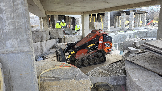 skid-steer on makeshift "road"