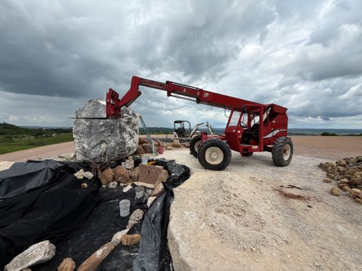 heavy equipment placing boulder